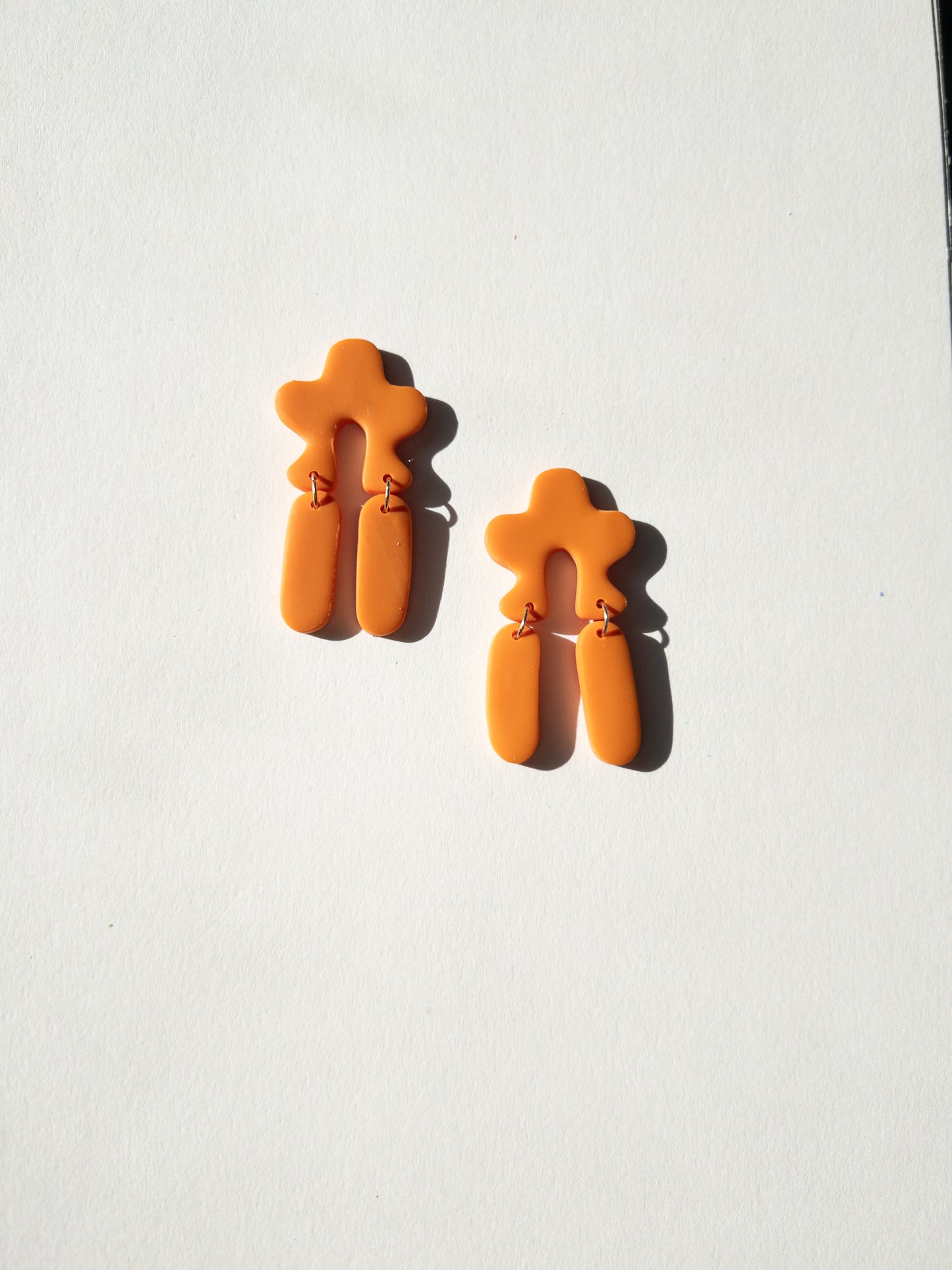 the wavy arch orange popsicle dangle earrings