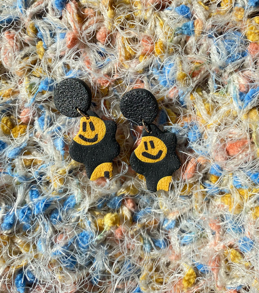 smiley on black long squiggle blob earring