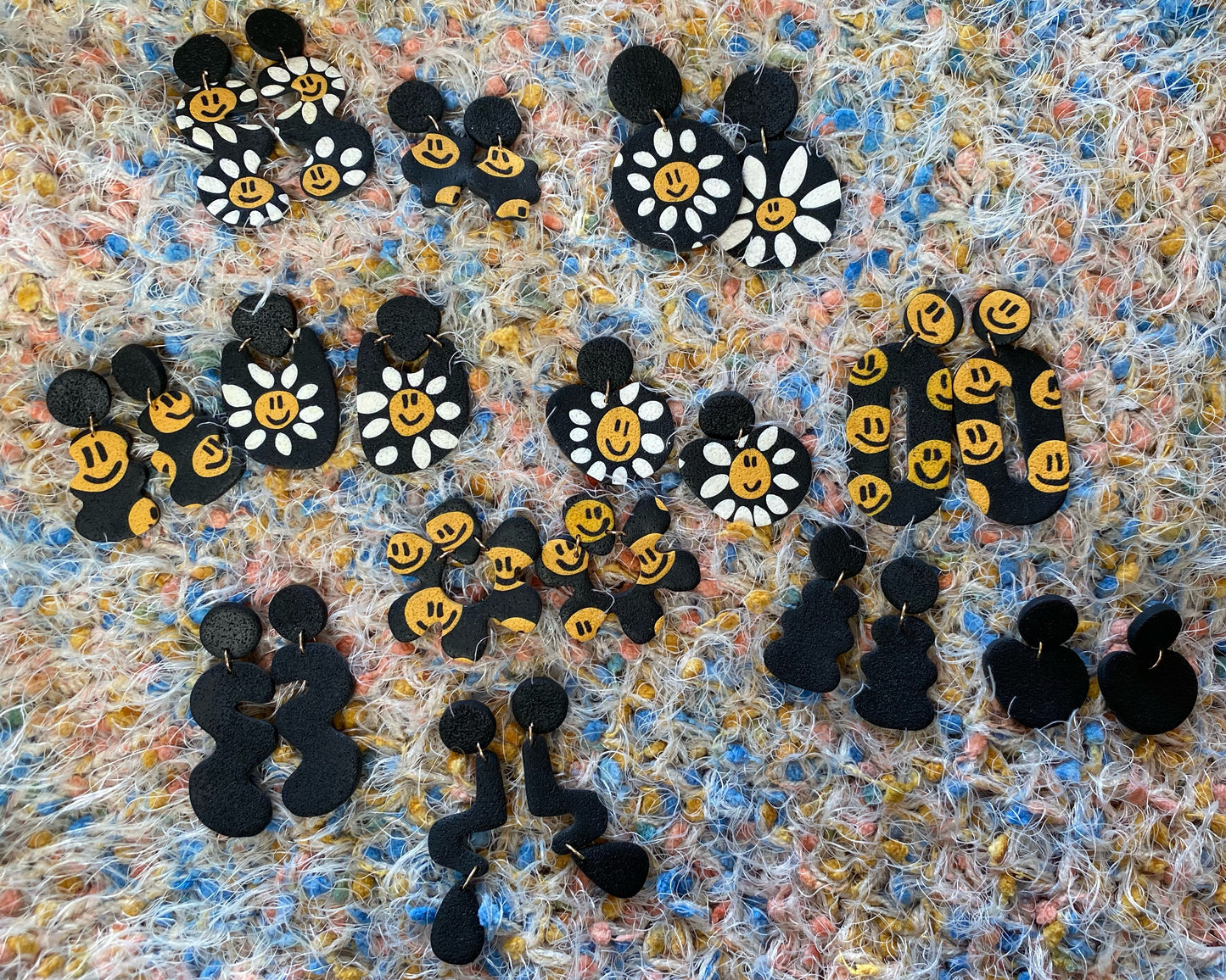 daisy smiley on black abstract U earrings
