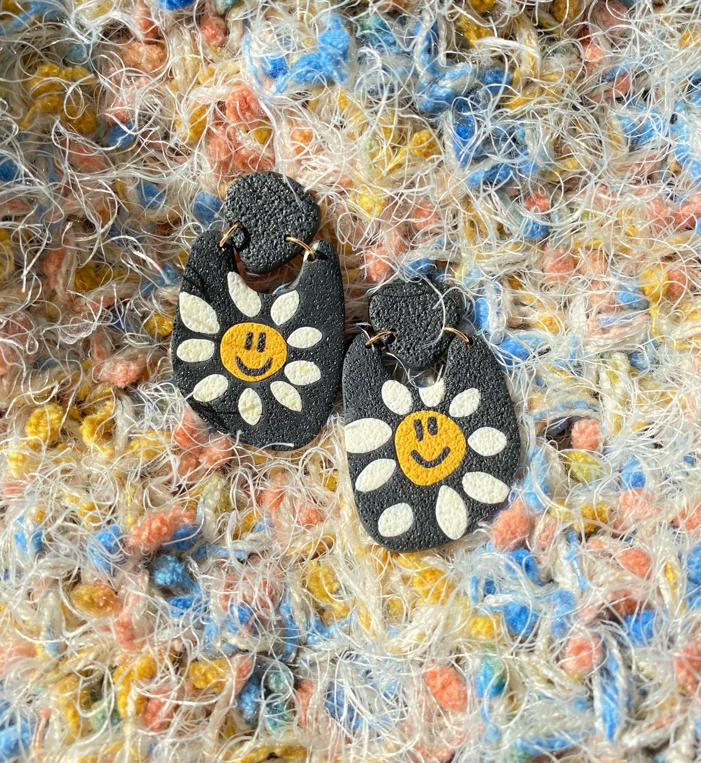 daisy smiley on black abstract U earrings