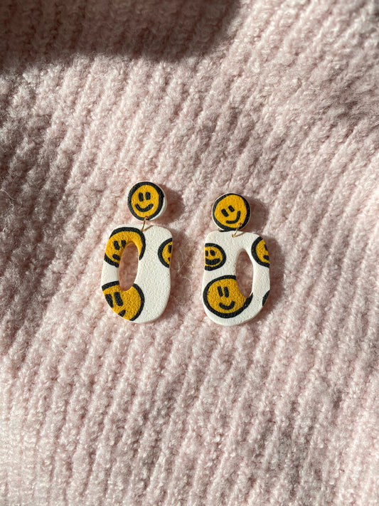 smiley on white oval donut earrings